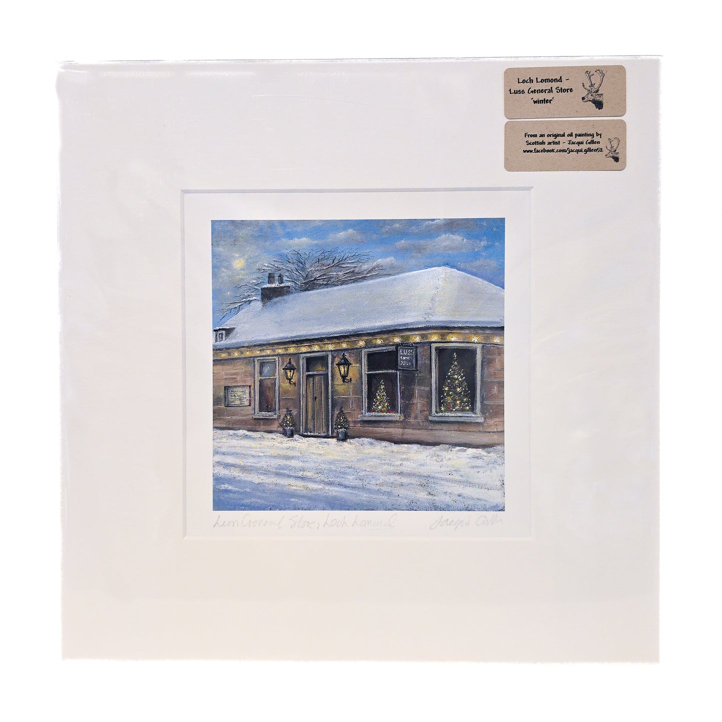 Framed winter scene of a house with snow on the roof, on a white background.