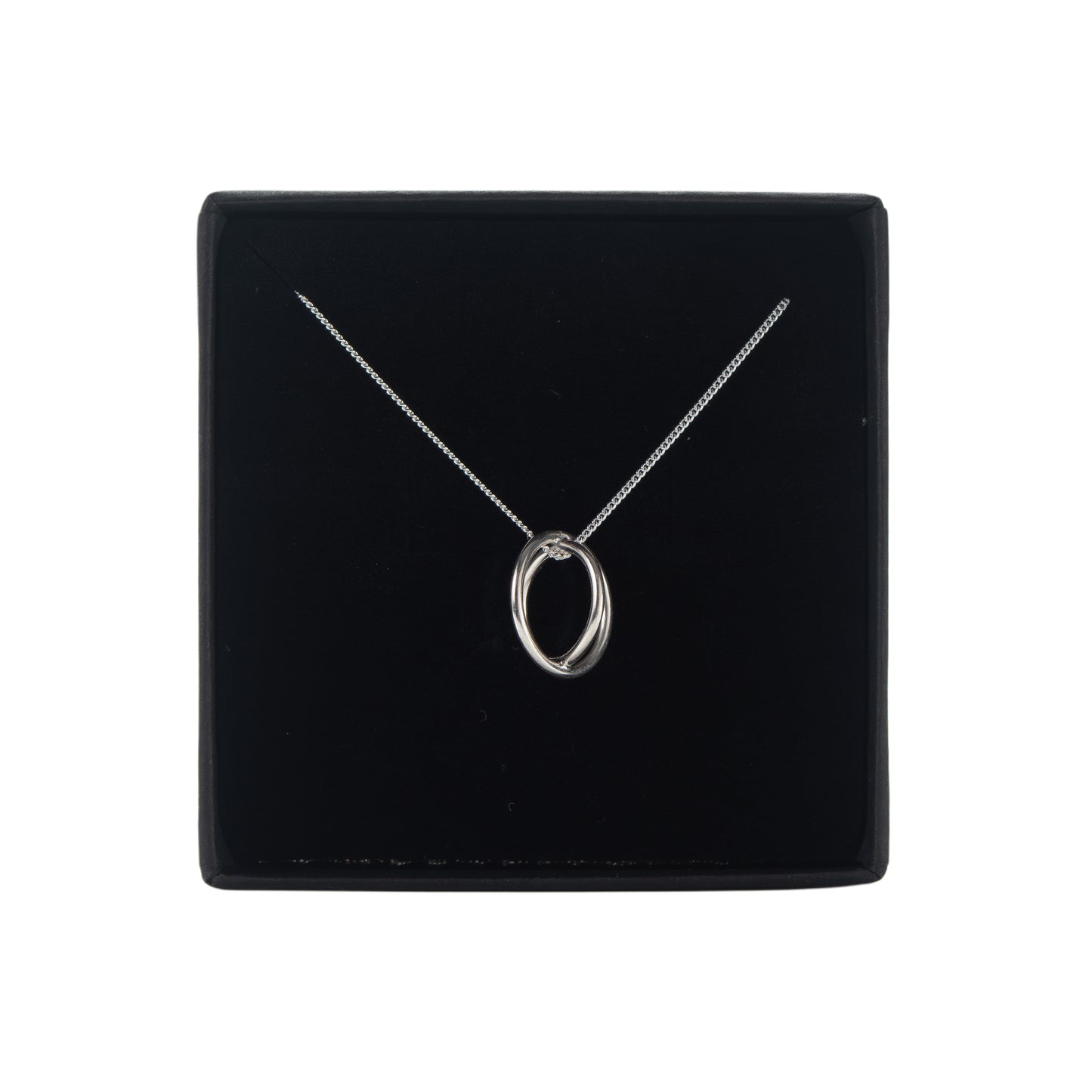 Silver aperture necklace with a pendant on a black display box