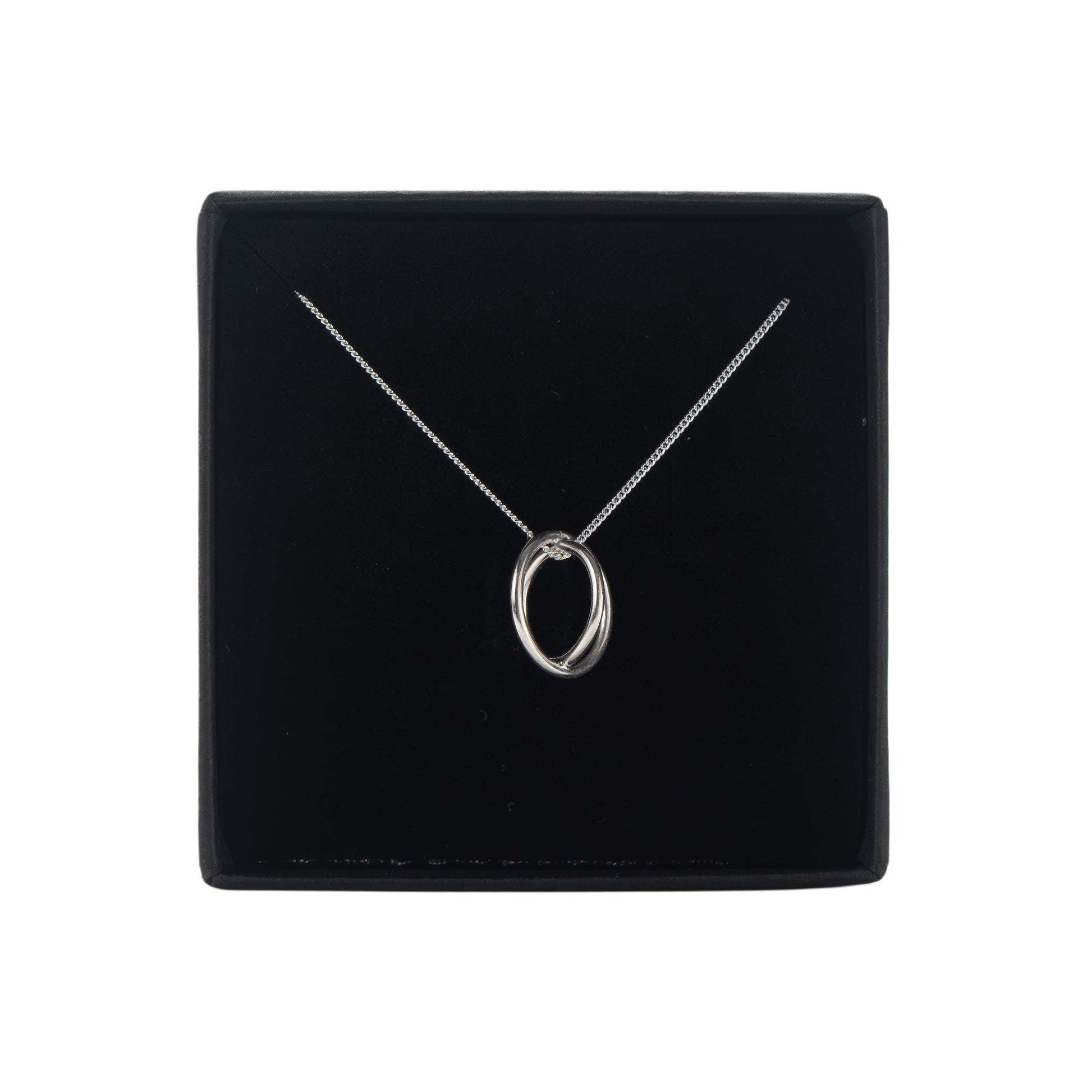 Silver aperture necklace with a pendant on a black display box