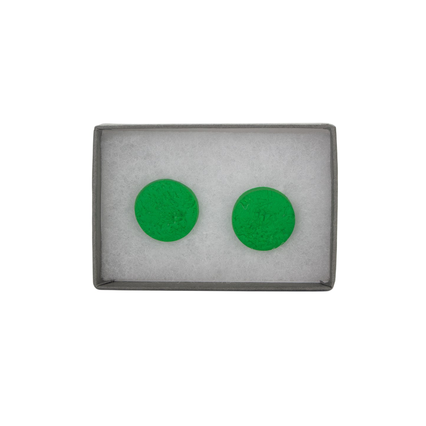 Green circular earrings in a gray box on a white background