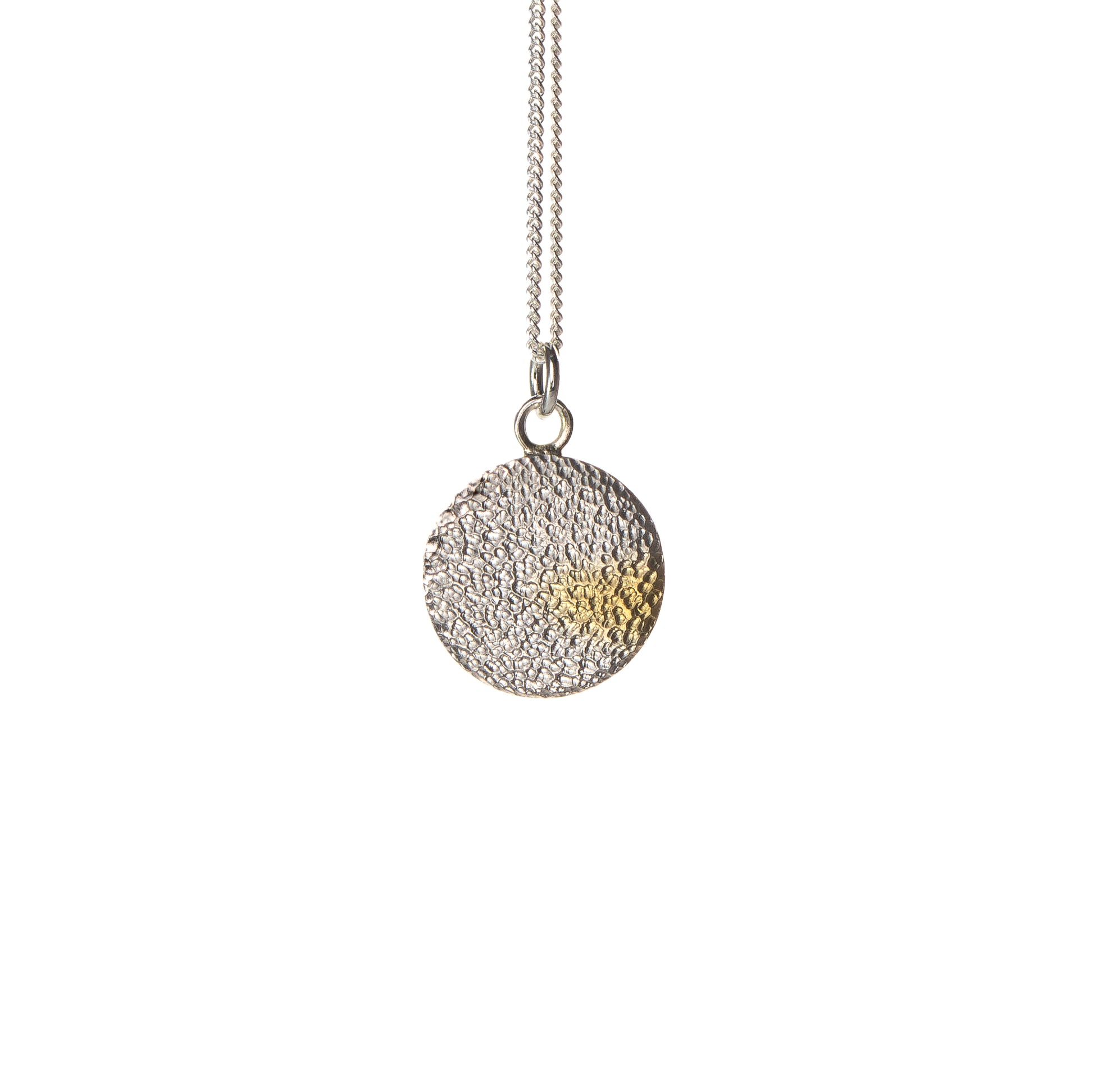 Handmade silver disc pendant with textured finish and gold detail by Bianca O’Neill Jewellery.
