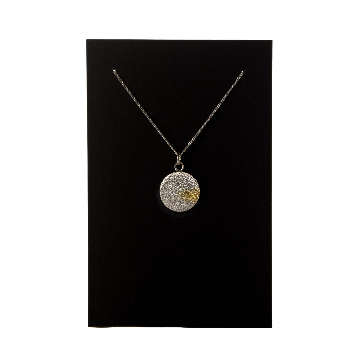 Necklace with a round pendant on a black card