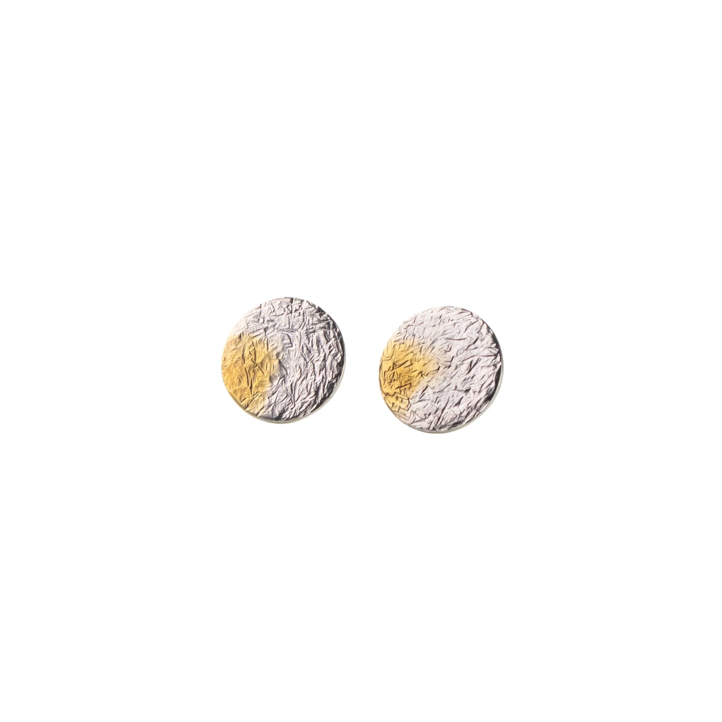 Pair of round earrings with gold and silver finishes on a white background