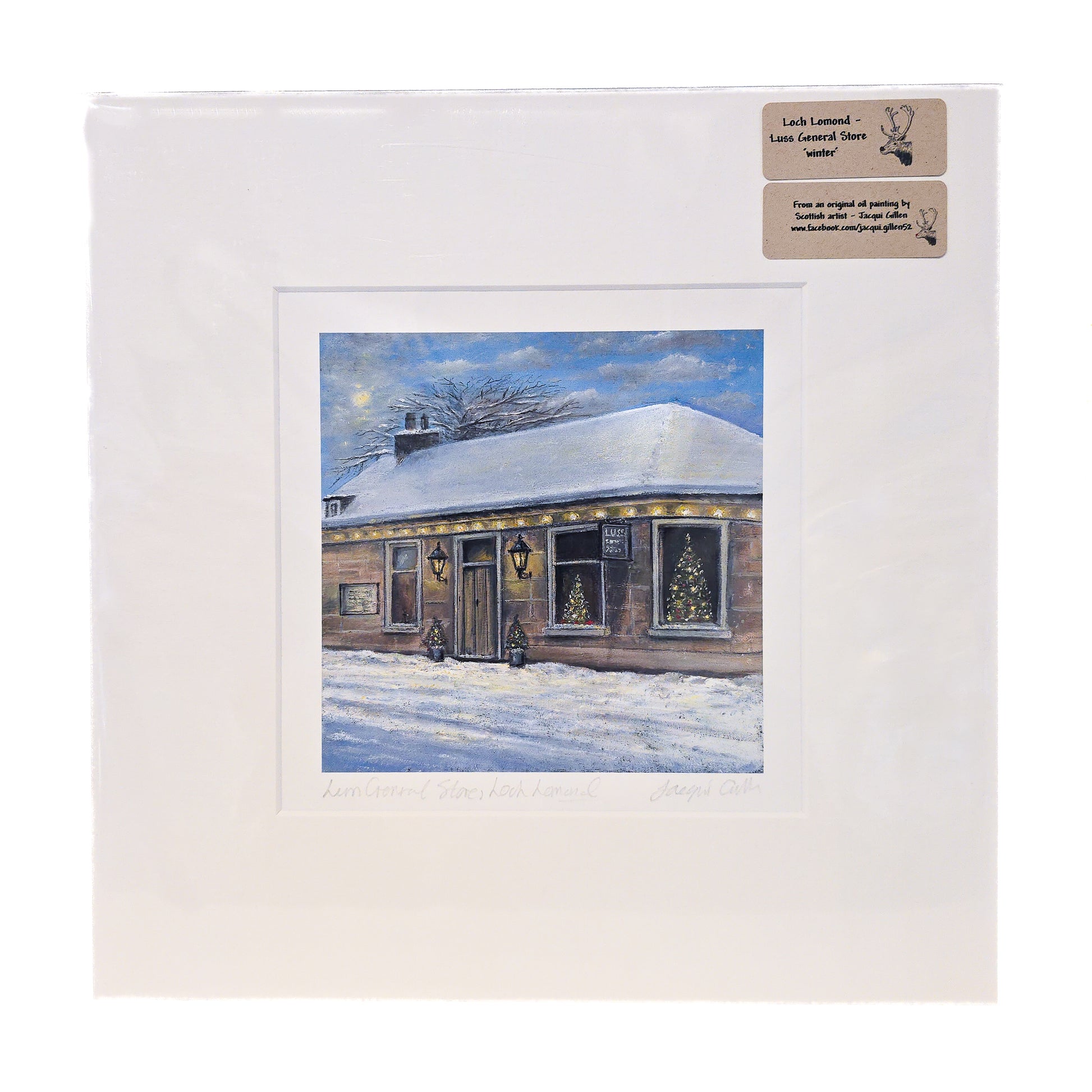 Framed winter scene of a house with snow on the roof, on a white background.