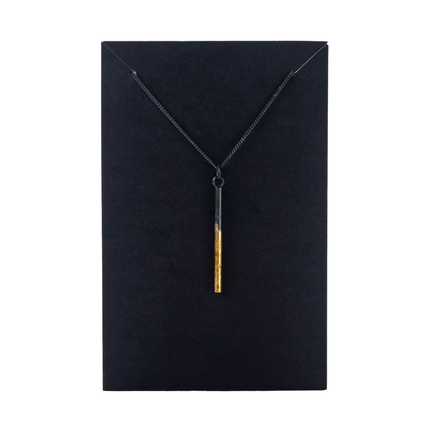Necklace with a gold pendant on a black card