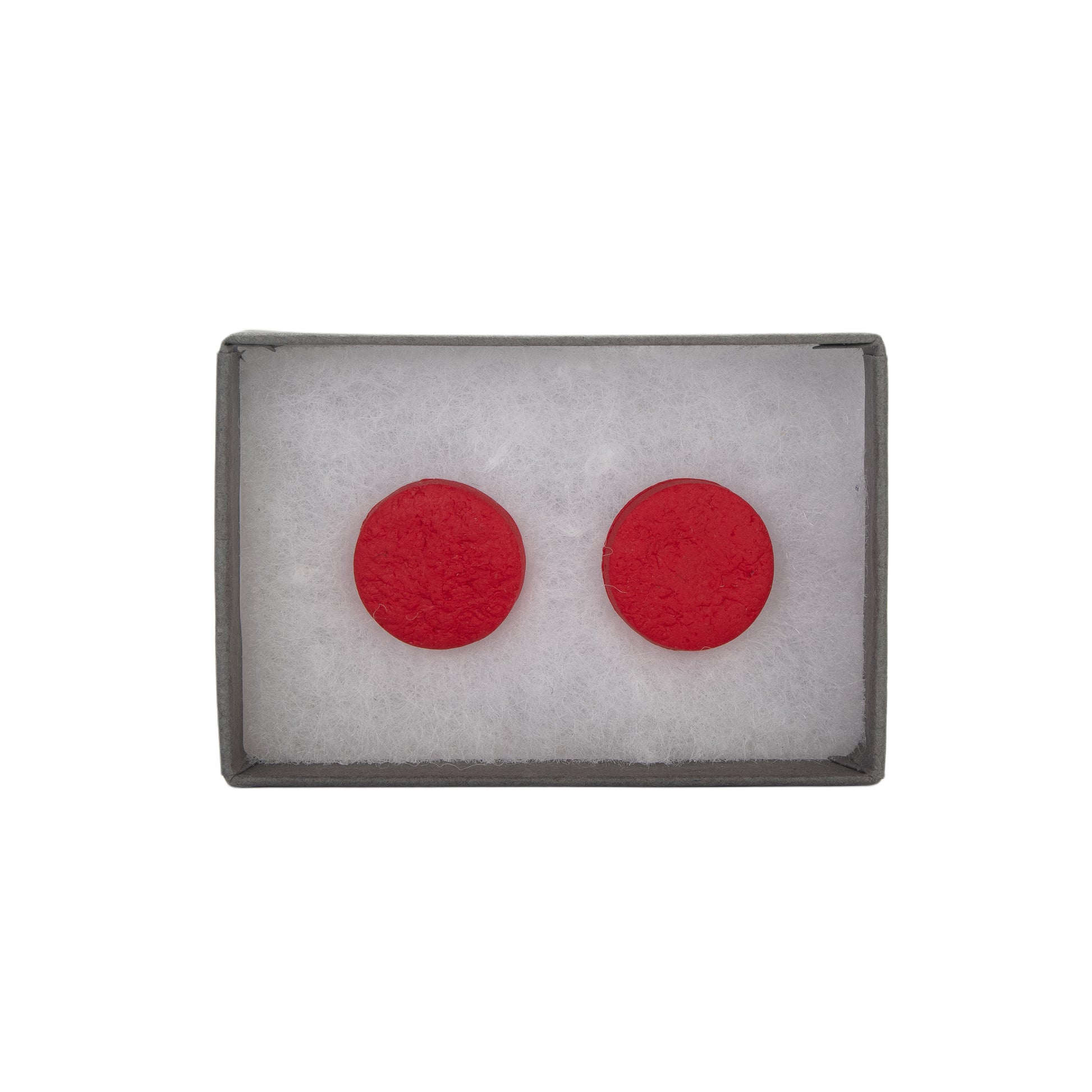 Red circular earrings in a gray box on a white background