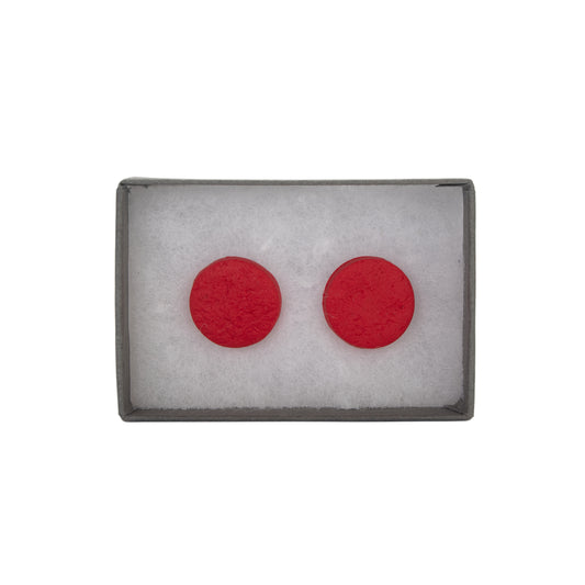 Red circular earrings in a gray box on a white background